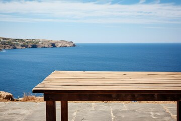 close up of a wooden table with ocean sea view in background