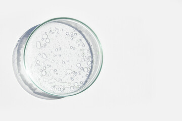 Petri dish. Petri cups with liquid. Kit. Chemical elements, oil, cosmetics. Gel, water, molecules, viruses. Close-up. On a white background.