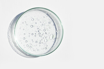 Petri dish. Petri cups with liquid. Kit. Chemical elements, oil, cosmetics. Gel, water, molecules, viruses. Close-up. On a white background.