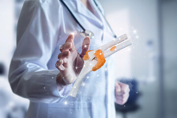 Doctor working on virtual computer screen with joint in knee .