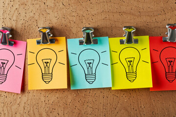 Creative Brainstorming Concept with Lightbulb Drawing on Colorful Sticky Notes