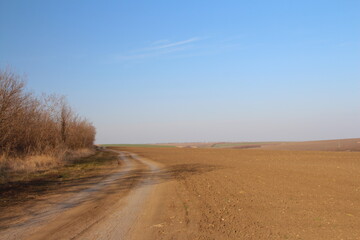 A dirt road with a rainbow