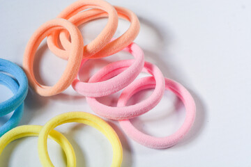 Fototapeta premium Heap of various hair ties. Multicolored elastics isolated on white background