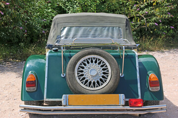 Vintage green car with soft top	