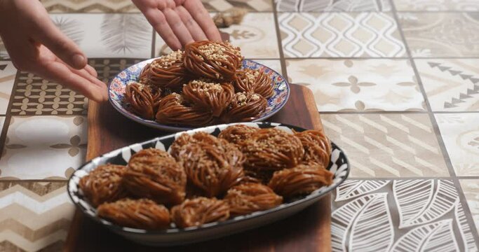 With meticulous care, bouchnikha chebakia is elegantly presented on the plate, a visual and culinary delight that celebrates the beauty and complexity of Moroccan pastry artistry.