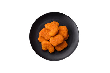 Delicious fresh crispy chicken nuggets on a dark concrete background