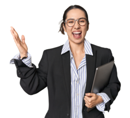Professional young Caucasian businesswoman with laptop on studio background receiving a pleasant surprise, excited and raising hands.