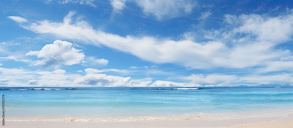 Poster serenity at seaside: tranquil beachscape with fluffy clouds and azure sky