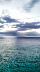 cloudy sky over the ocean with a great pattern on the surface