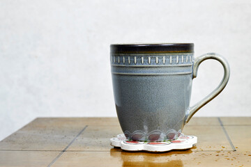handmade ceramic mug with interesting design on wood table