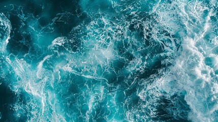 From above aerial view of turquoise ocean water with splashes and foam for abstract natural background and texture - obrazy, fototapety, plakaty