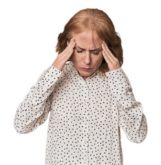 Redhead mid-aged Caucasian woman in studio touching temples and having headache.