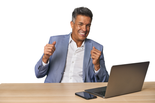 Elegant businessman at desk with laptop dancing and having fun.