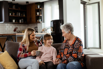 Generational bonding, grandmother, daughter, and grandchild sharing stories on a cozy afternoon