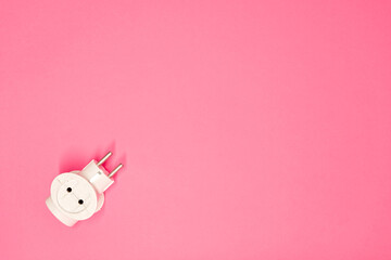 White dirty old adapter for many sockets, 220 volt plug. European splitter, on a pink background,...