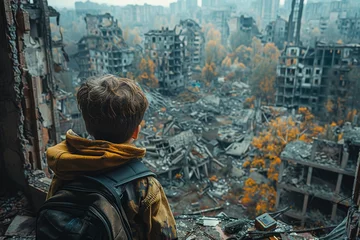 Foto op Canvas Child looking at its destroyed hometown by war © Dejan