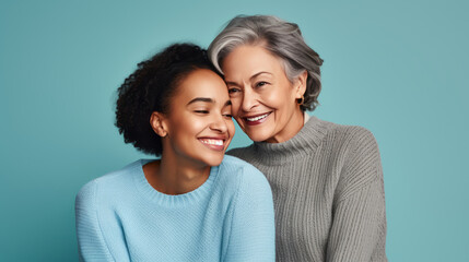 Lovely fun smiling happy caucasian elder parent mom and daughter hugging on a blue background. Parent-Child Relationships. AI generated - obrazy, fototapety, plakaty