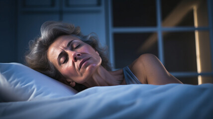 Stressed sad tired exhausted caucasian middle-aged mature woman suffering from hot flash in bed. Menopause, night sweat. 


