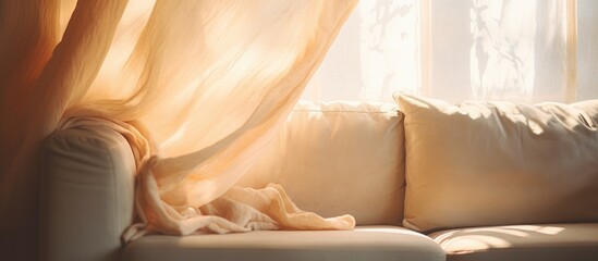 A white couch is positioned under a window, adorned with a curtain. The warm sunlight brightens the scene, casting a gentle glow on the furniture.