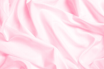Waves and patterns of crumpled natural satin pink color fabric.