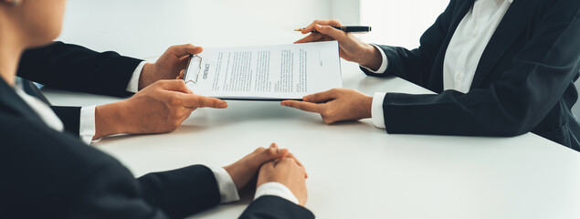 Business executive signing contract agreement document on the bale with the help from company attorney or lawyer service in law firm office. Business investing and finalizing legal processing. Shrewd - obrazy, fototapety, plakaty