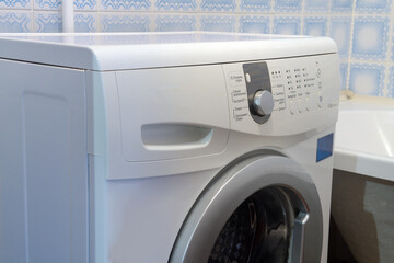 Washing machine in the bathroom. Washing machine, close-up.