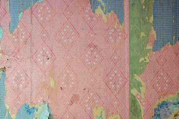 Old wallpaper on the wall. Old wallpaper for texture or background.