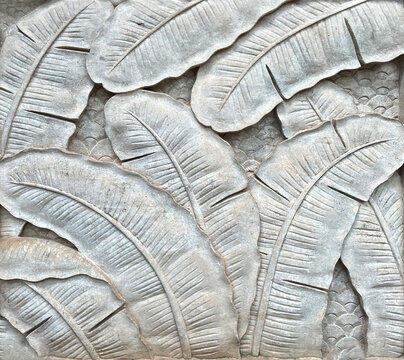 Low-relief leaf craft in cement style.