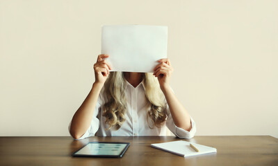 Woman showing and holding white blank sheet of paper document for text working with computer