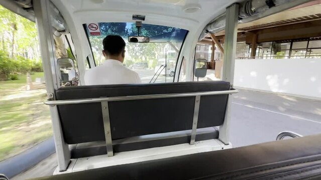 Travellers ride a buggy cart car In a hotel, Thailand
