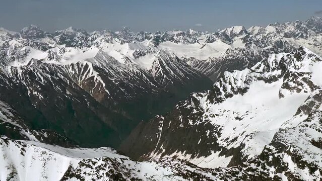 Beechcraft Bonanza airplane wingtip flies over Lake Clark Pass in Alaska. Mount Redoubt in the background. Small aircraft are only way to see many areas of Alaska.