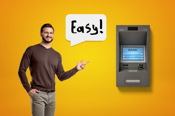 Man pointing to an ATM machine saying 'Easy'