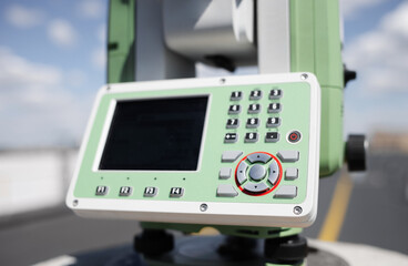Total station against a background of blue sky close up. Geodetic equipment for lengths and angles surveying, permanently installed on pilar
