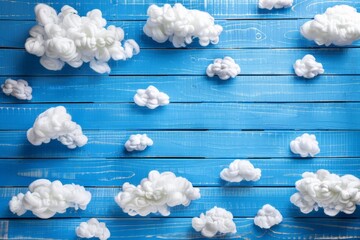 A blue wooden table topped with white clouds against a clear sky. Cute background