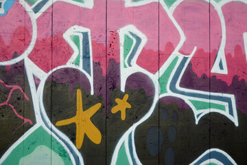 Colorful background of graffiti painting artwork with bright aerosol outlines on wall. Old school street art piece made with aerosol spray paint cans. Contemporary youth culture backdrop