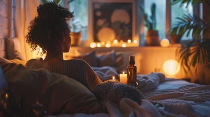 Foto op Canvas Woman relaxing in cozy bedroom with candles, warm lighting, and home plants. Self-care and wellness at home concept © ANStudio