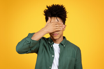 Exhausted young african american man with covering face with hand