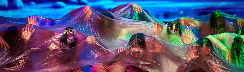 Dancers Performing Behind a Transparent Curtain On Stage Under Blue Light - obrazy, fototapety, plakaty