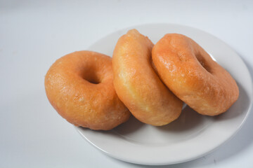 Close up of original donuts without toppings on a white background. Isolated objects