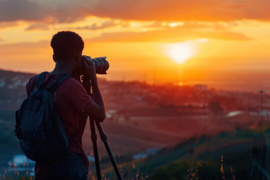 An African American male photographer capturing a sunrise landscape with a DSLR on a tripod.