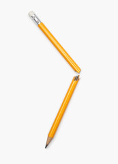 Broken pencil on a white vertical background. Yellow graphite pencil broken in two halves close-up....