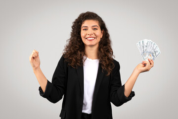 Happy businesswoman with cash celebrating success