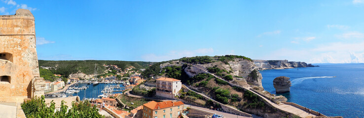 Obraz premium View of the port and the bay of Bonifacio, a magnificent town in Corsica, nicknamed the Island of Beauty. The city overlooks the Mediterranean Sea and is famous for its citadel and gigantic cliffs