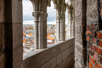 The narrow stone passageway with arched windows looking out over the city at the top of the...