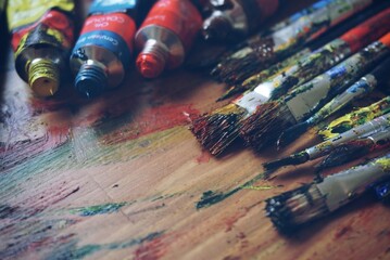 Color remnants cling to the paintbrushes, silent witnesses to the vivid artwork they've recently crafted.