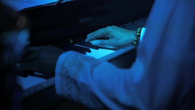 Black pianist playing on stage
