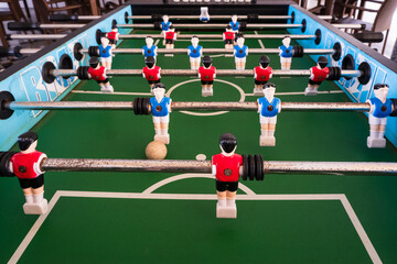 Table soccer or table football game machine with blue and red team matching