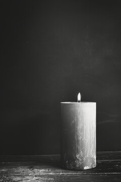 Sympathy card black and white color photo, candle, black background. Copy Space. Generative AI