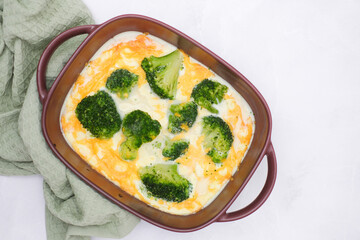 Quiche broccoli. Egg Frittata ready for baked. Baked egg frittata with spinach, cheese, broccoli, milk. Served on grey background..