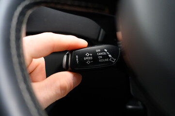 Driver holding the cruise control stalk with there hand